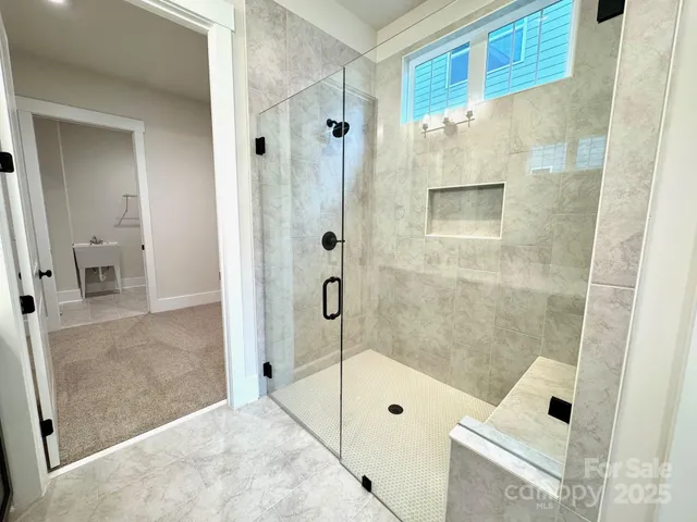 a bathroom with a shower and a sink