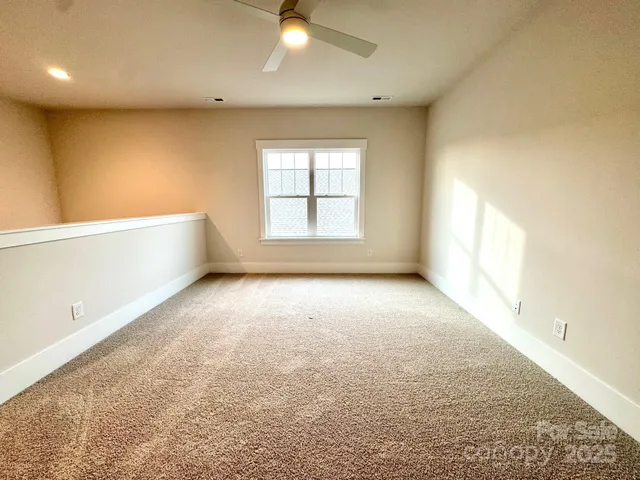 an empty room with a empty space and windows