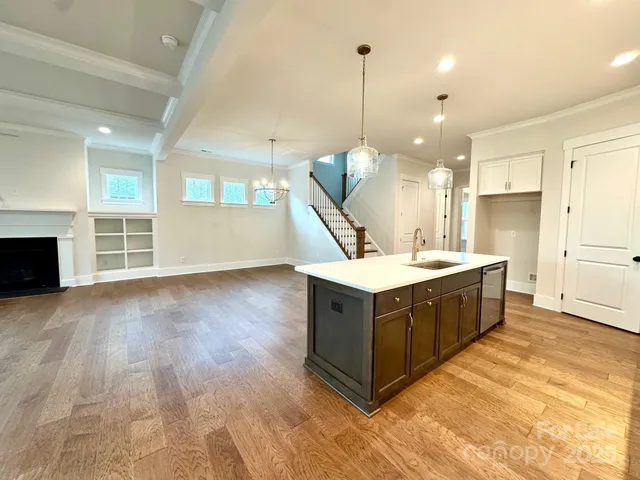 a kitchen with stainless steel appliances kitchen island granite countertop a sink a counter space and cabinets