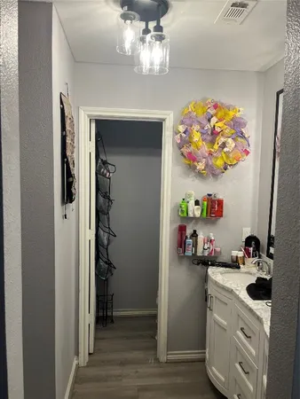 a kitchen with a refrigerator and a chandelier