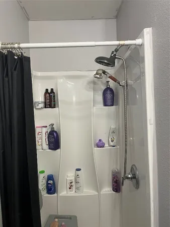 a bathroom with a shower and a sink