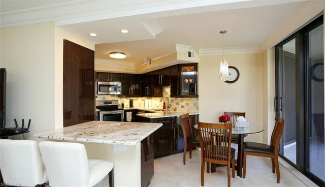 a kitchen with a table and chairs in it