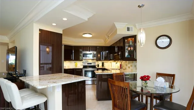 a kitchen with a dining table and chairs