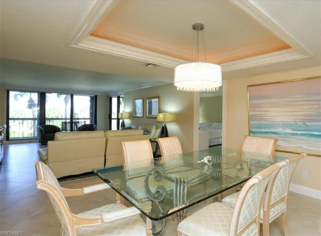 a living room with fireplace furniture and a chandelier