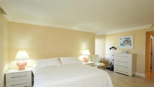 a bedroom with a bed and dressers