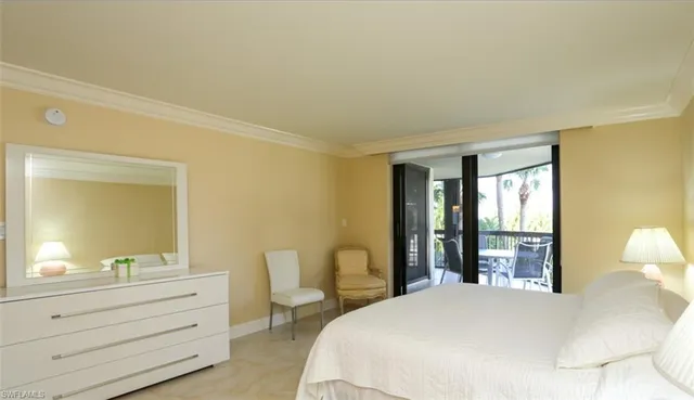 a bedroom with a bed and large windows