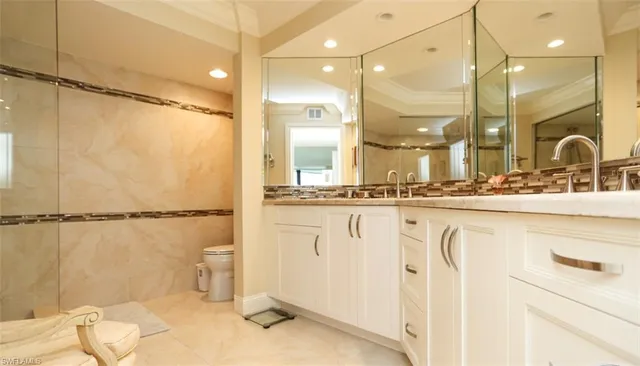 a bathroom with a sink mirror and a shower