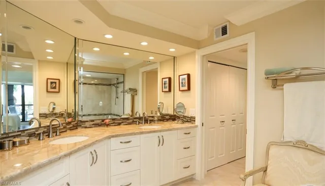 a bathroom with a double vanity sink mirror and double
