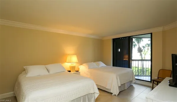 a bedroom with two beds and a window
