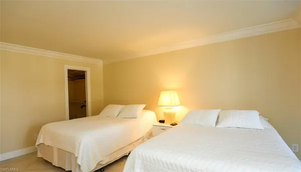 a bedroom with a bed and lamp