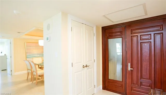 a view of a hallway with a dining room