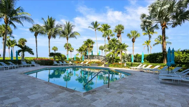a view of swimming pool with a patio and a garden