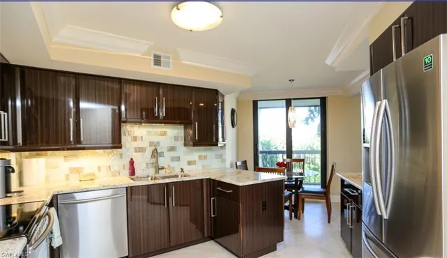 a kitchen with refrigerator cabinets and a sink