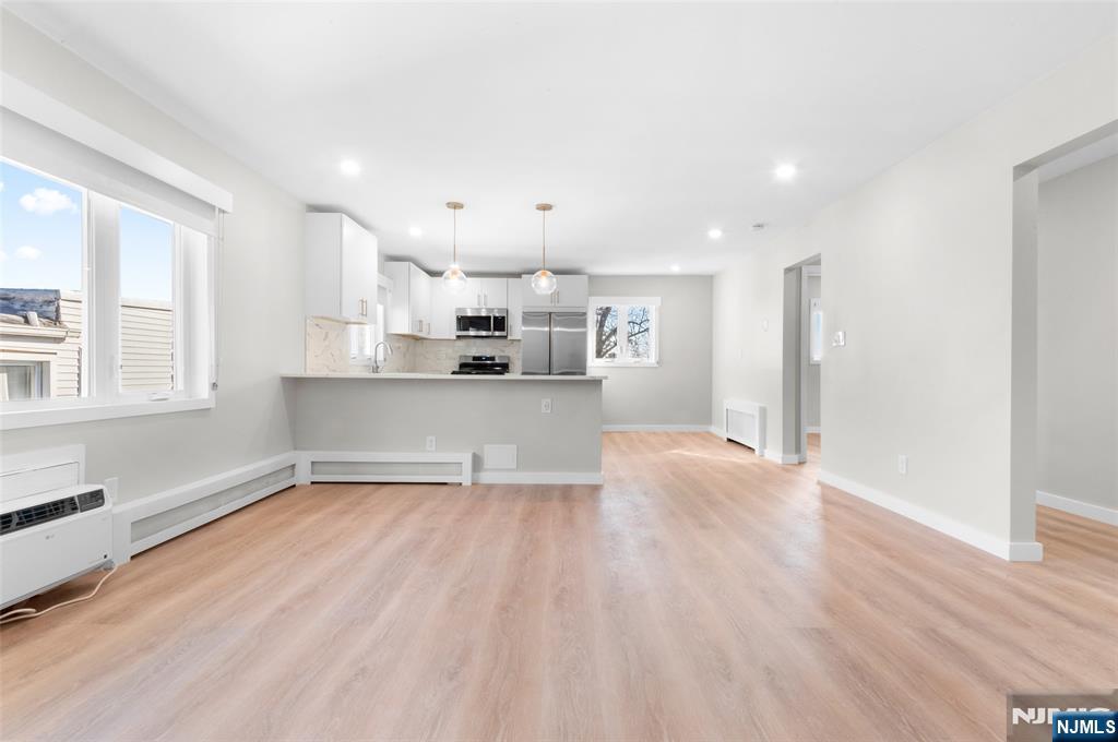 539 Undercliff Avenue, Unit 4 Edgewater, NJ 07020 - Photo 5 of 15 a view of a kitchen with a sink and wooden floor