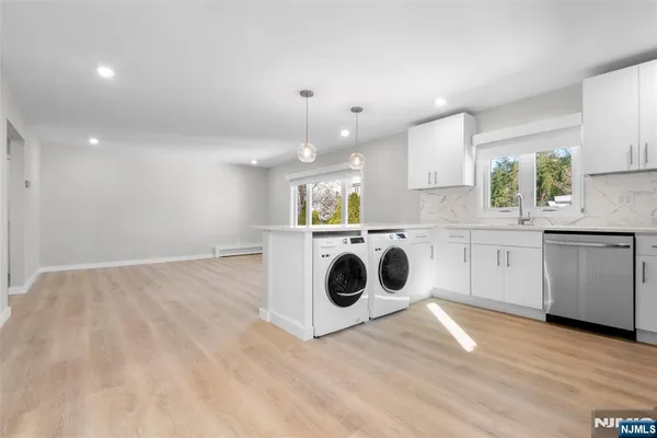 a view of a kitchen with stove top oven and cabinets