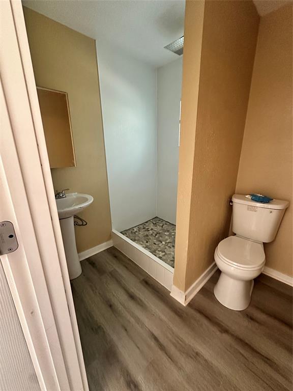 4101 North 19th Street Waco, TX 76708 - Photo 7 of 8 Full bath featuring wood finished floors and a stall shower