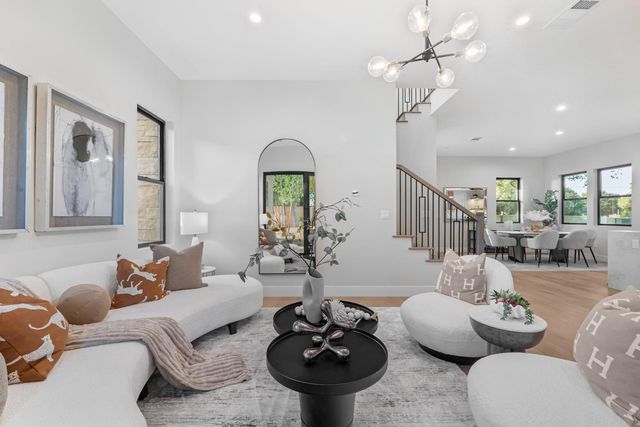 a living room with furniture a chandelier and a chandelier