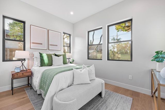 a bedroom with a bed and wooden floor