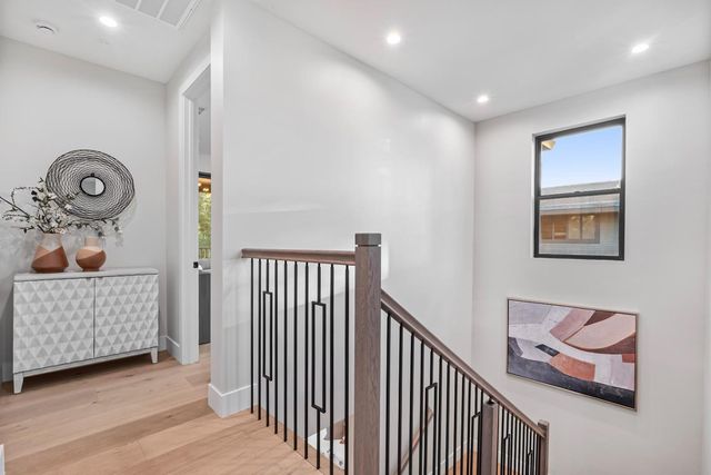 a spacious bedroom with a large bed and a large window