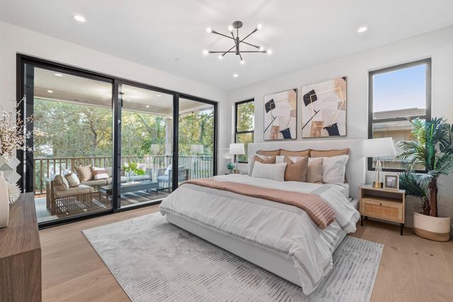 a bedroom with a large bed and a large window