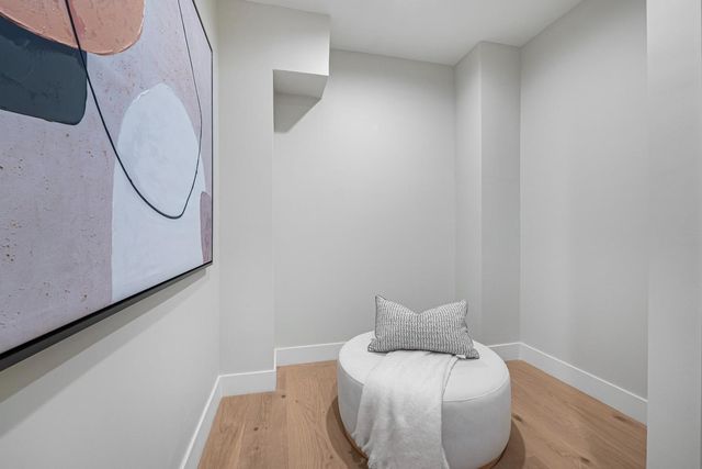 a spacious bathroom with a toilet sink and mirror