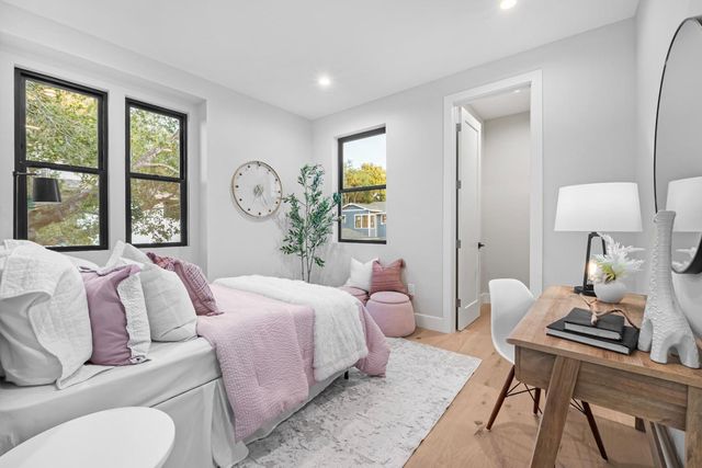 a bedroom with a large bed and a large window