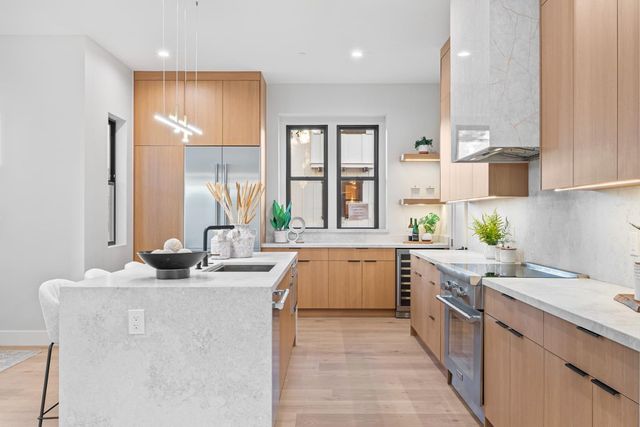 a kitchen with a sink stove and cabinets