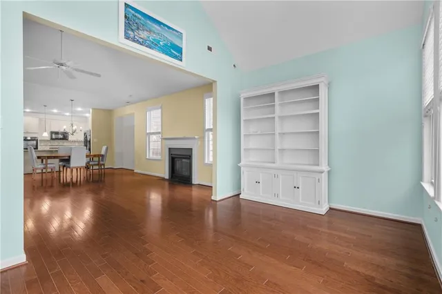 a view of a livingroom with furniture wooden floor and a fireplace