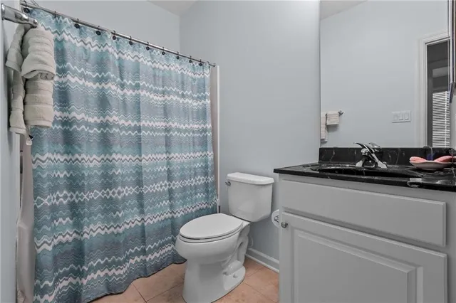 a bathroom with a toilet and a shower curtain