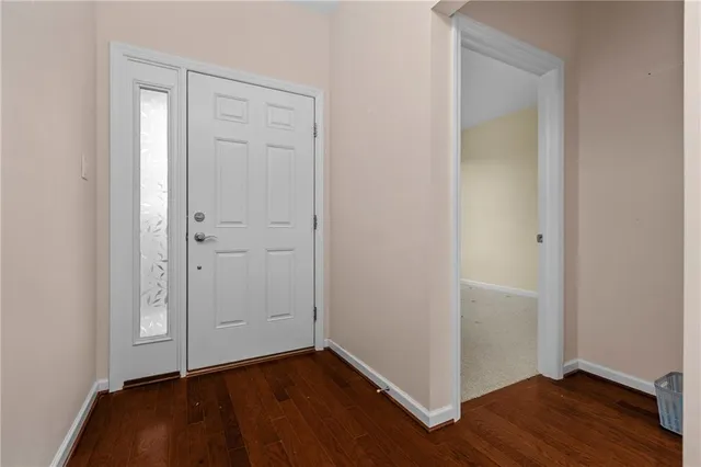 an empty room with wooden floor and closet