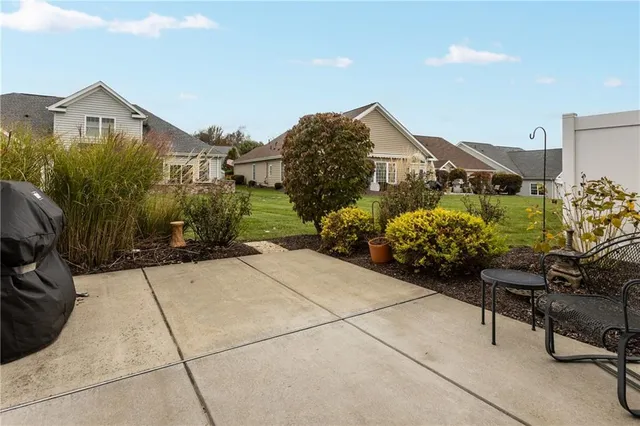a view of a house with sitting area and garden