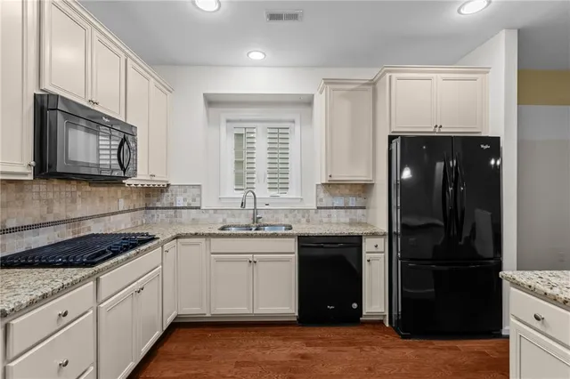 a kitchen with a sink stove and refrigerator
