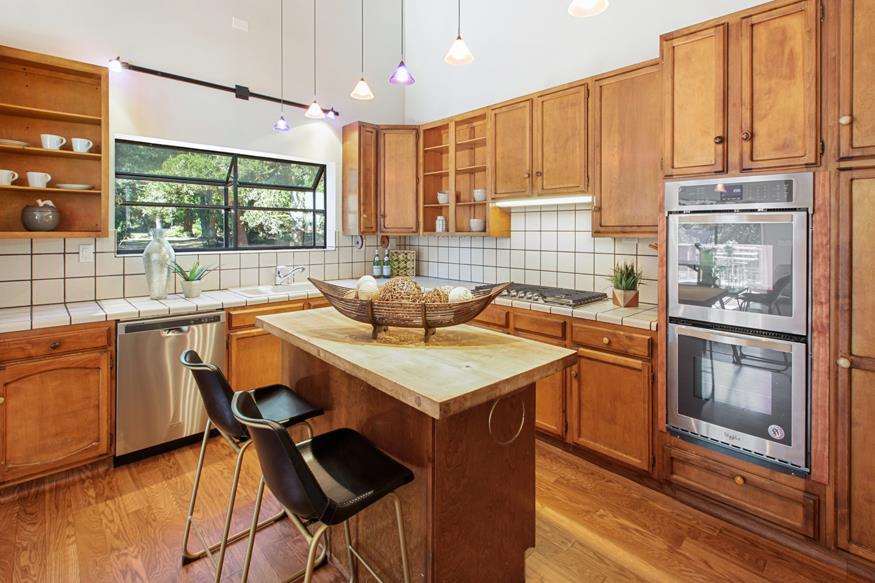 56 Big Tree Road Woodside, CA 94062 - Photo 19 of 31 a kitchen with stainless steel appliances granite countertop a stove a sink and a refrigerator