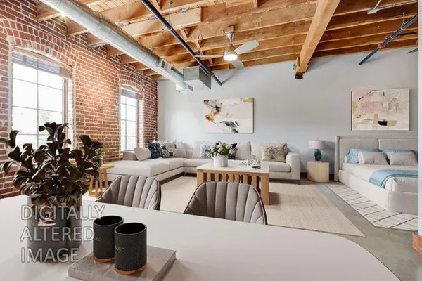 a bedroom with furniture and a large window