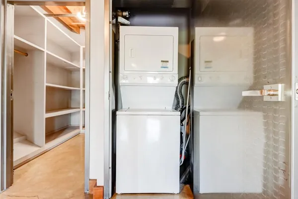 a view of walk in closet with empty racks