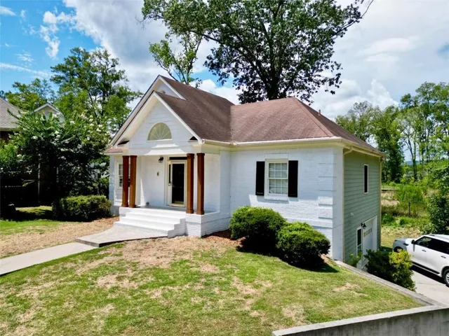 a front view of a house with a garden
