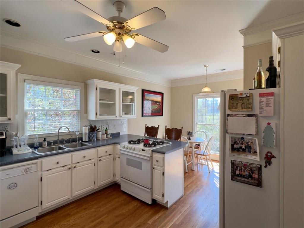 11 Stonegable Drive Northwest Rome, GA 30165 - Photo 12 of 27 a kitchen with stainless steel appliances a stove a sink cabinets and wooden floor