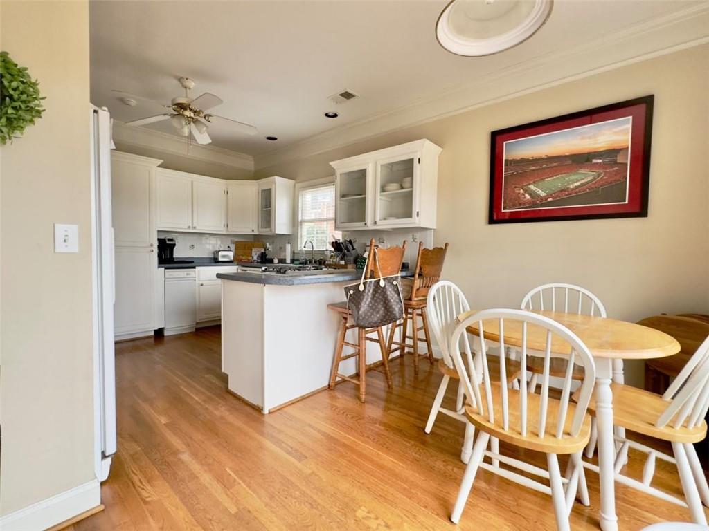11 Stonegable Drive Northwest Rome, GA 30165 - Photo 13 of 27 a kitchen with stainless steel appliances granite countertop a stove top oven a sink a dining table and chairs