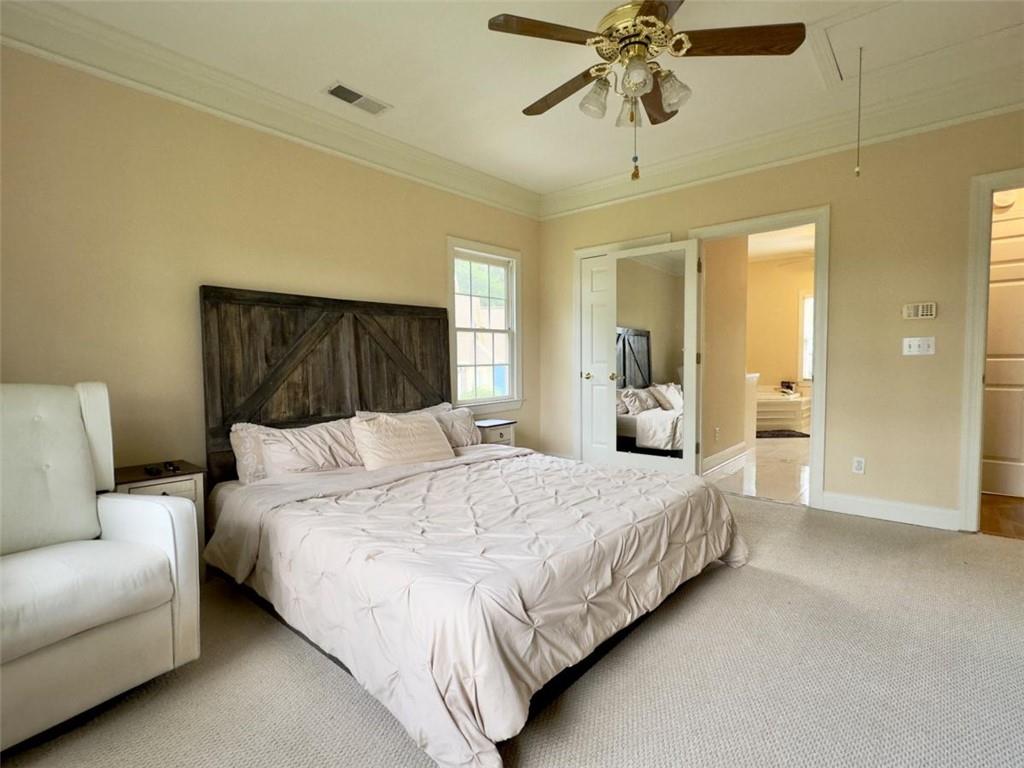 11 Stonegable Drive Northwest Rome, GA 30165 - Photo 18 of 27 a bedroom with a large bed and ceiling fan