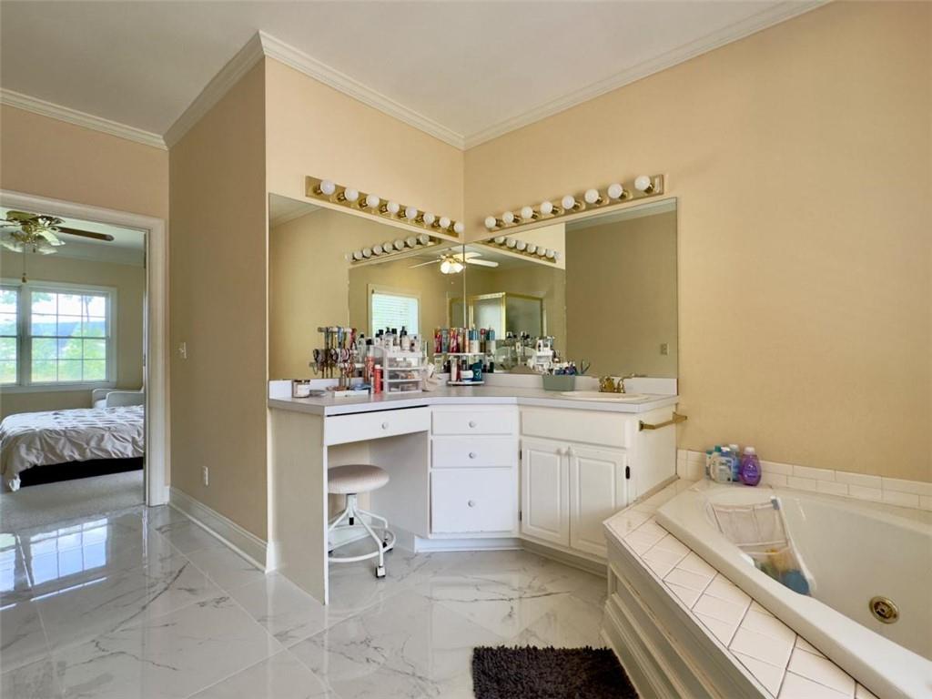 11 Stonegable Drive Northwest Rome, GA 30165 - Photo 19 of 27 a bathroom with a tub sink and a mirror
