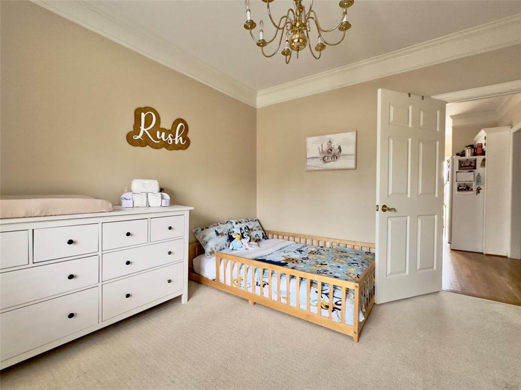 11 Stonegable Drive Northwest Rome, GA 30165 - Photo 21 of 27 a bedroom with a bed and a chandelier
