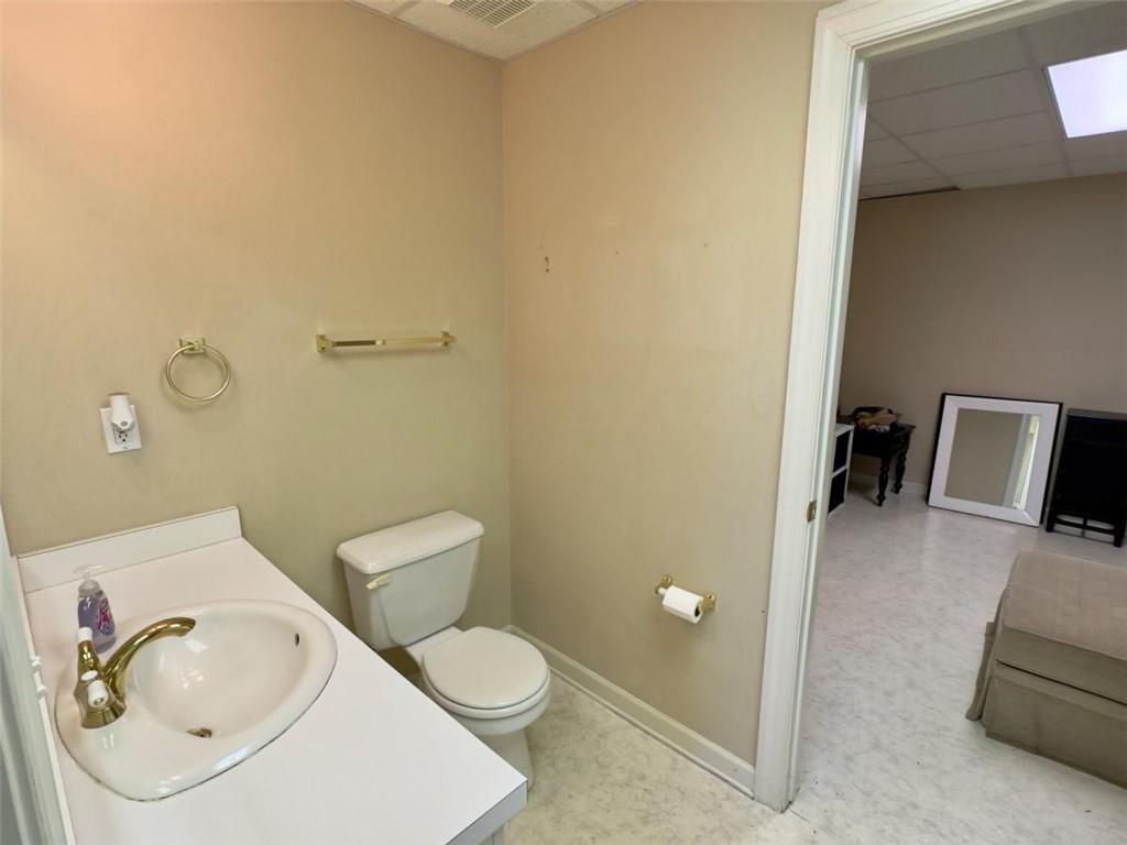 11 Stonegable Drive Northwest Rome, GA 30165 - Photo 24 of 27 a bathroom with a toilet a sink and mirror