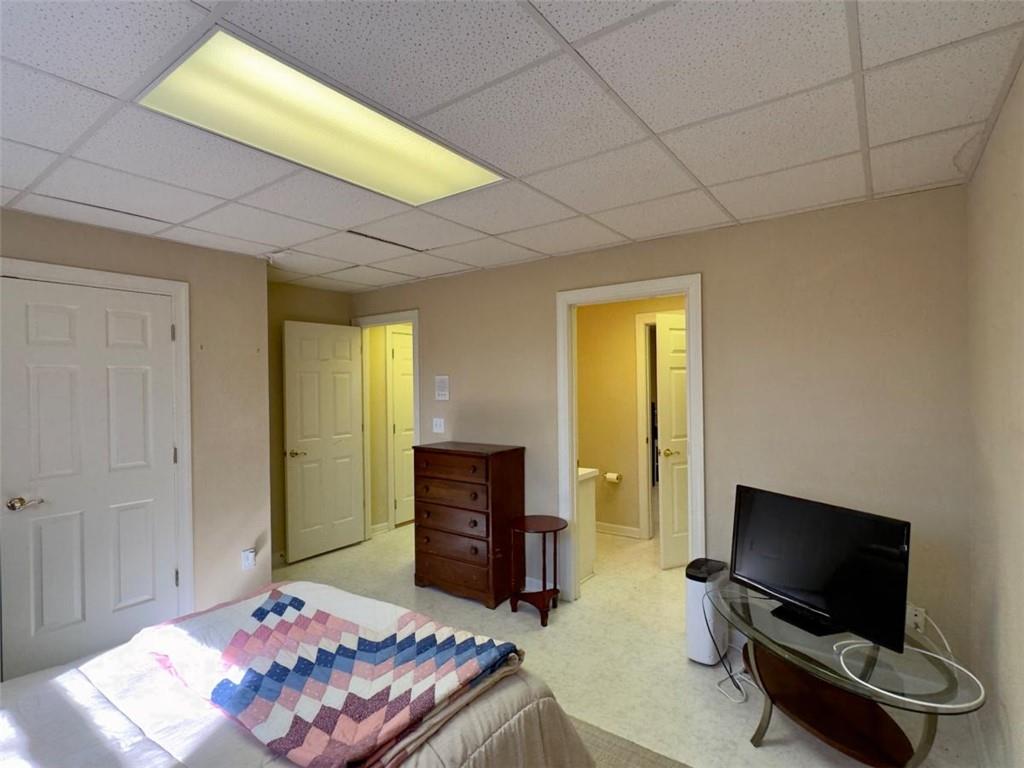 11 Stonegable Drive Northwest Rome, GA 30165 - Photo 25 of 27 a bedroom with furniture and a flat screen tv