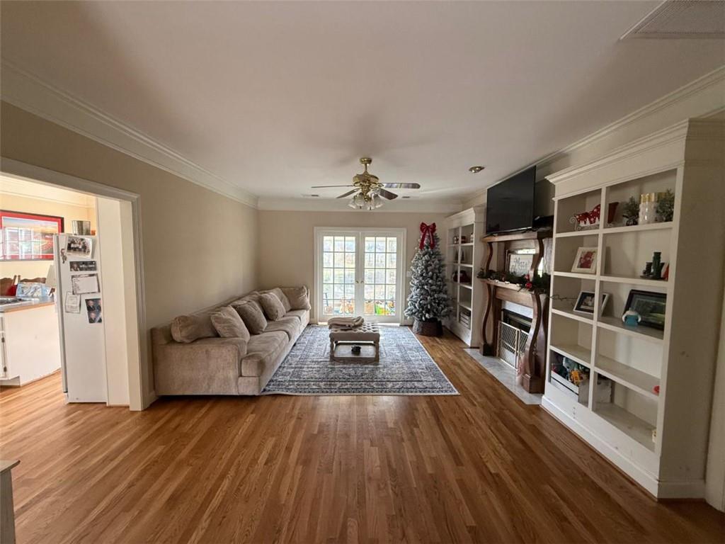 11 Stonegable Drive Northwest Rome, GA 30165 - Photo 6 of 27 a living room with furniture and a book shelf