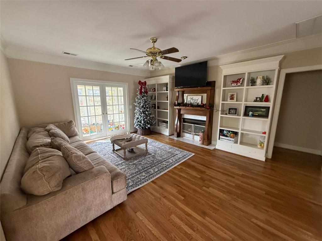 11 Stonegable Drive Northwest Rome, GA 30165 - Photo 7 of 27 a living room with fireplace furniture and a wooden floor