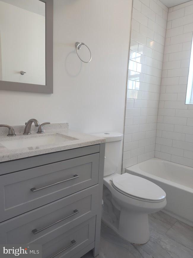 4230 6th Street Southeast, Unit 1 Washington, DC 20032 - Photo 5 of 25 a bathroom with a sink a toilet and shower