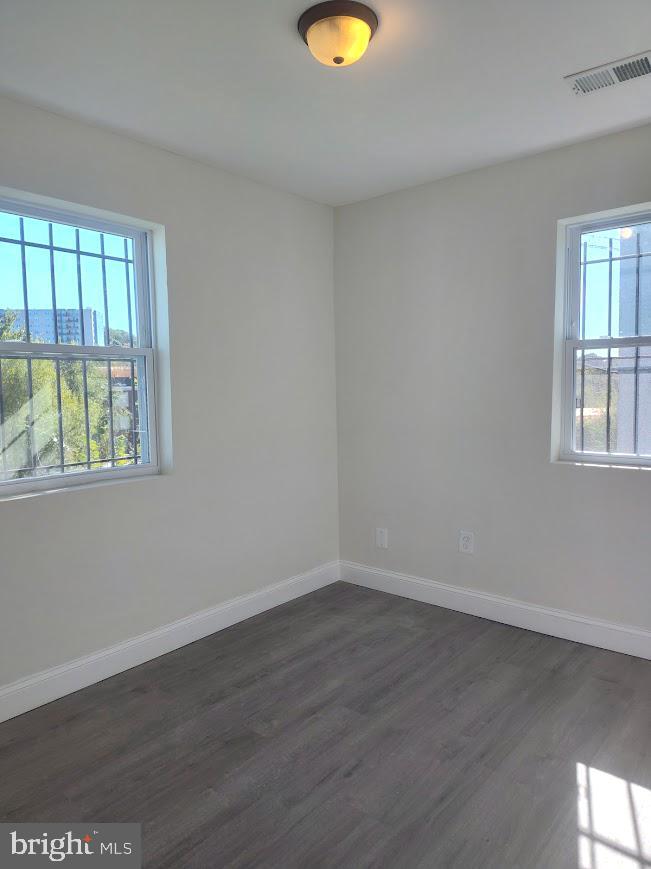 4230 6th Street Southeast, Unit 1 Washington, DC 20032 - Photo 8 of 25 wooden floor in an empty room with a window