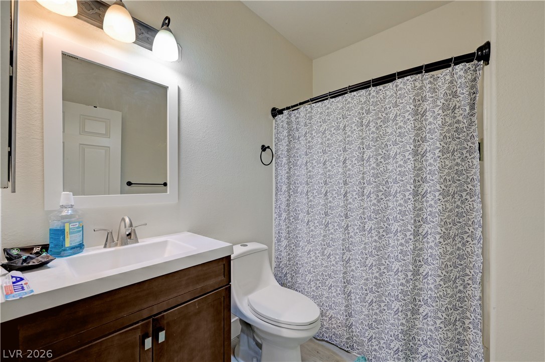 4730 East Craig Road, Unit 1155 Las Vegas, NV 89115 - Photo 16 of 41 A well-lit bathroom featuring a modern vanity and a white shower curtain with a subtle floral pattern.