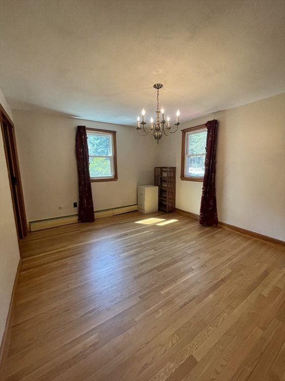 7 Albert Street Billerica, MA 01821 - Photo 13 of 33 a view of a livingroom with wooden floor and kitchen