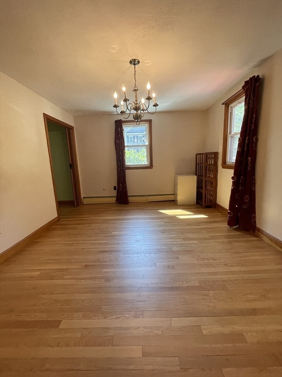 7 Albert Street Billerica, MA 01821 - Photo 14 of 33 wooden floor in an empty room with a window